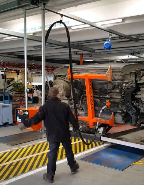 Convoynort - Gantry crane with suspended clamp under balancer and hydraulic power pack.
